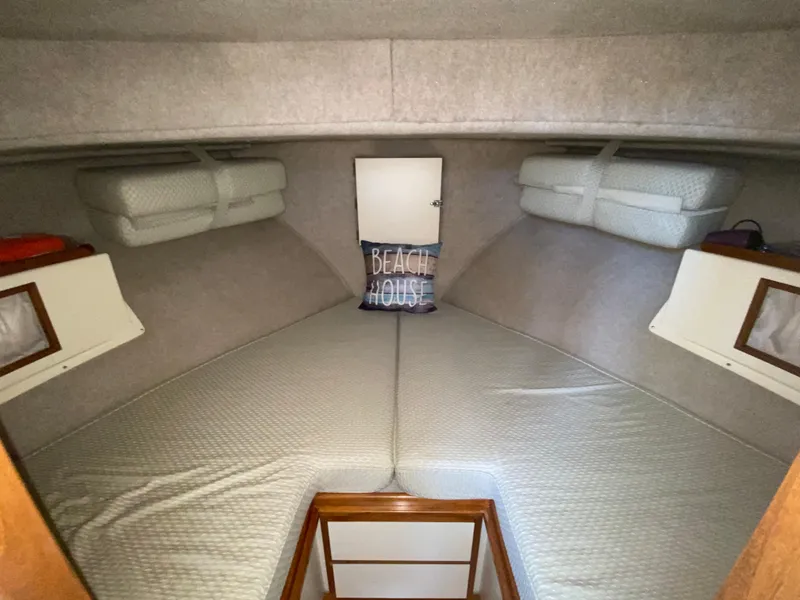 Slide: The Image of Interior cabin of 1998 Camano Troll 31 boat with cozy bedding and "Beach House" pillow. - 43