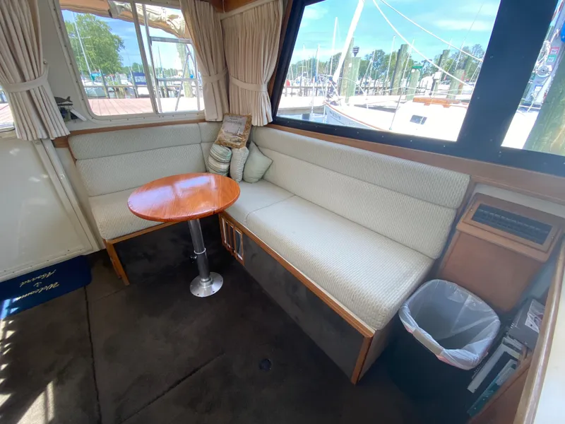 Slide: The Image of Interior of 1998 Camano Troll 31 boat with cozy seating and round table. - 45