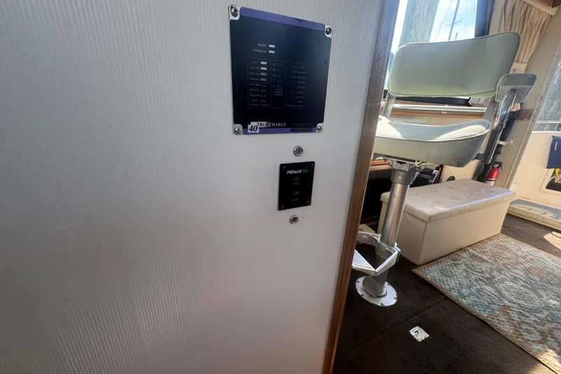 Slide: The Image of Interior of 1998 Camano Troll 31 boat with control panel and seating area. - 48