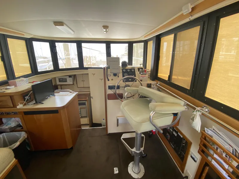 Slide: The Image of Interior of 1998 Camano Troll 31 boat with helm, seating, and navigation equipment. - 5