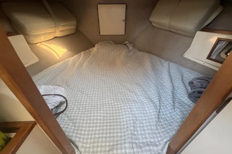 Slide: The Image of Cozy sleeping area in a 1998 Camano Troll 31 boat cabin with soft lighting. - 50