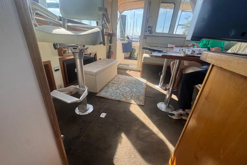 Slide: The Image of Interior of 1998 Camano Troll 31 boat with seating and table. - 51