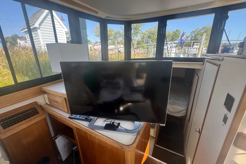 Slide: The Image of Interior of 1998 Camano Troll 31 boat with TV and scenic window views. - 54