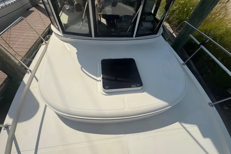 Slide: The Image of 1998 Camano Troll 31 boat deck with hatch, docked at marina. - 58