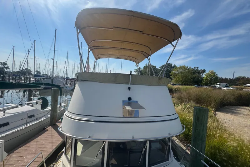 Slide: The Image of 1998 Camano Troll 31 boat docked at marina under clear blue sky. - 59