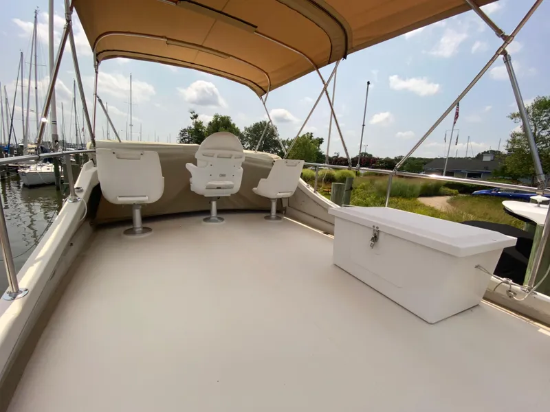 Slide: The Image of Flybridge of 1998 Camano Troll 31 with seating and storage, docked at marina. - 6