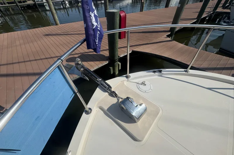 Slide: The Image of Bow of 1998 Camano Troll 31 boat with anchor and dock view. - 61