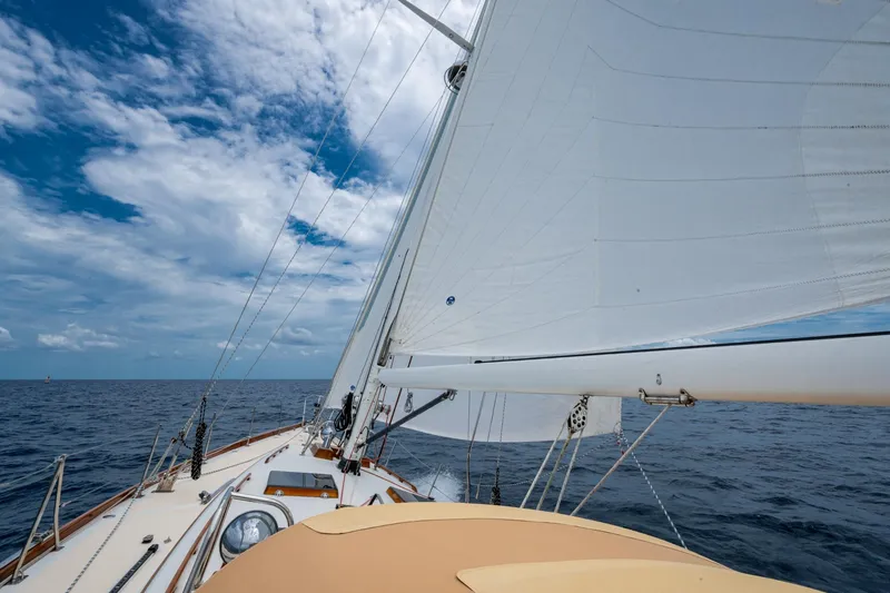 Slide: The Image of Hinckley Sou'wester Stoway Sloop sailing on open sea under clear blue sky. - 14