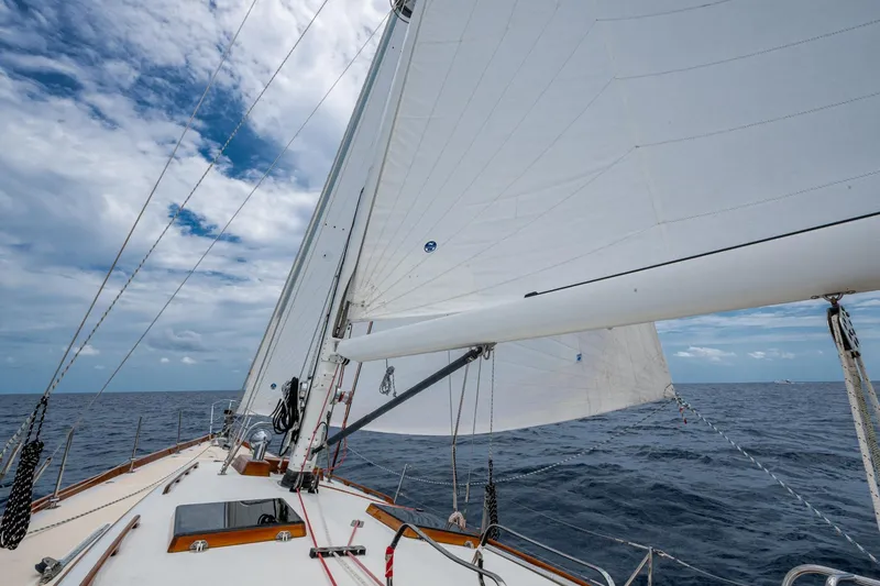 Slide: The Image of Hinckley Sou'wester Stoway Sloop sailing on open sea under cloudy sky, 2000 model. - 16