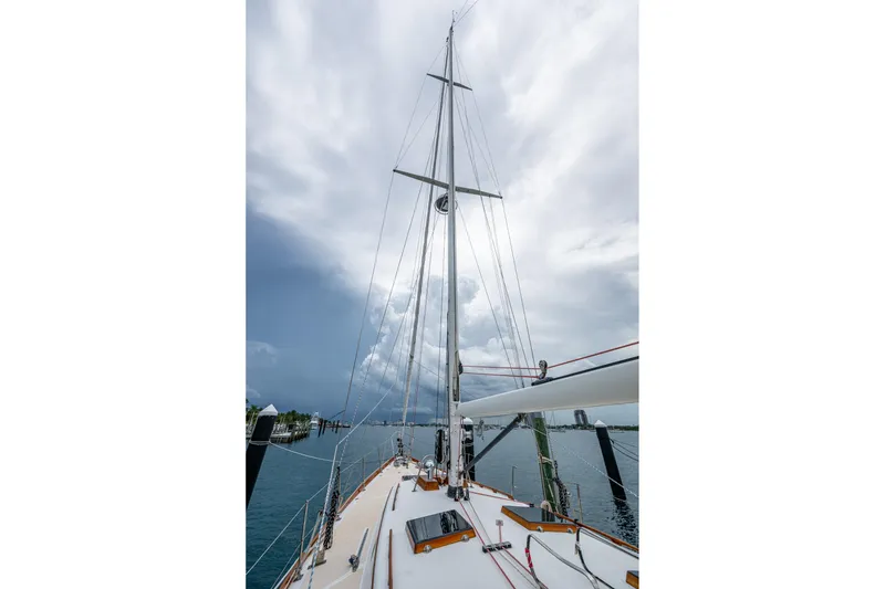 Slide: The Image of Hinckley Sou'wester Stoway Sloop 2000 sailboat with tall mast under cloudy sky. - 19