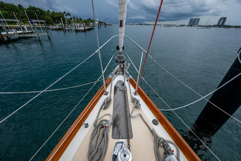 Slide: The Image of Bow view of 2000 Hinckley Sou'wester Stoway Sloop in a marina, under cloudy skies. - 21