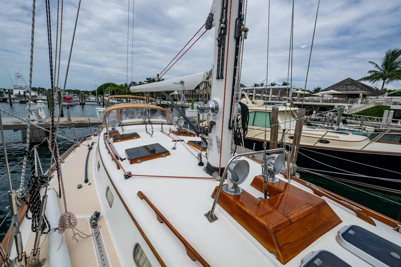 Slide: The Image of Hinckley Sou'wester Stoway Sloop 2000 docked at marina, showcasing deck and rigging. - 24