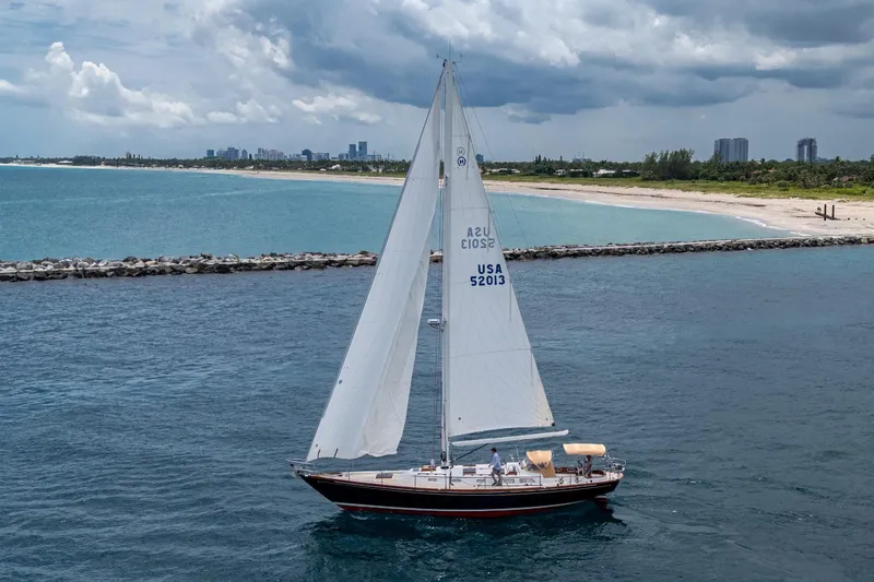 Slide: The Image of Hinckley Sou'wester Stoway Sloop sailing near a scenic coastline, 2000 model. - 3