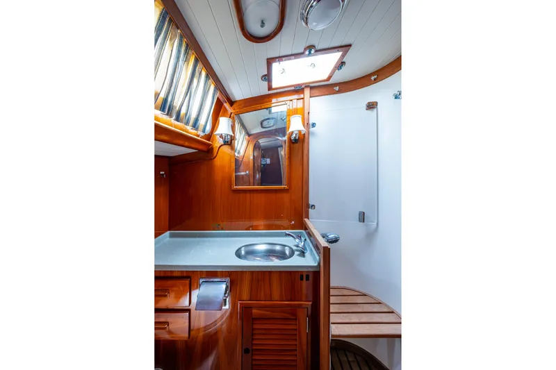 Slide: The Image of Hinckley Sou'wester Stoway Sloop 2000 bathroom with wooden cabinetry and modern fixtures. - 45