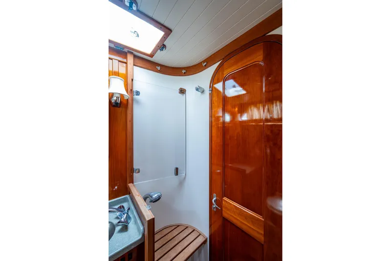 Slide: The Image of Hinckley Sou'wester Stoway Sloop 2000 bathroom with wooden finishes and modern fixtures. - 47