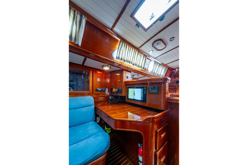 Slide: The Image of Interior of 2000 Hinckley Sou'wester Stoway Sloop with navigation station and wooden finish. - 49