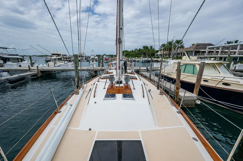 Slide: The Image of Hinckley Sou'wester Stoway Sloop 2000 docked at marina, surrounded by boats. - 22