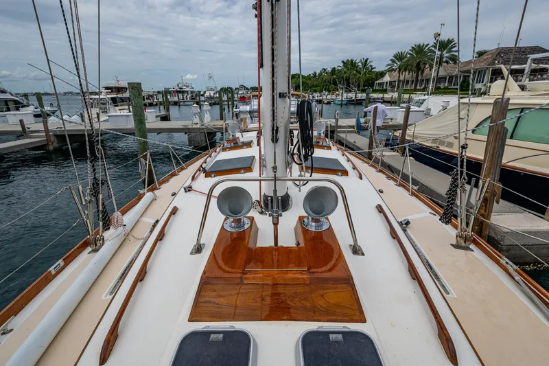 Slide: The Image of Hinckley Sou'wester Stoway Sloop 2000 docked at marina, showcasing deck and rigging. - 23