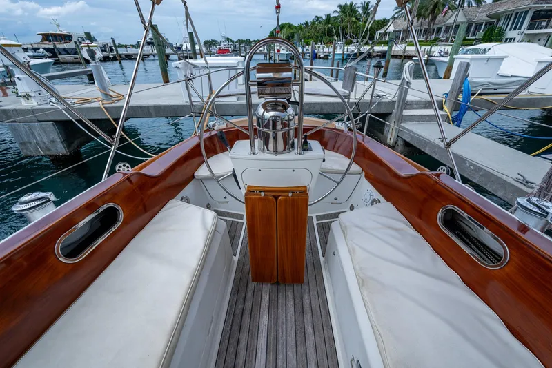 Slide: The Image of Hinckley Sou'wester Stoway Sloop 2000 cockpit with wooden accents and marina view. - 26