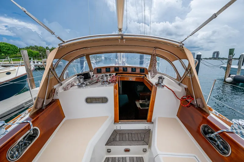 Slide: The Image of Hinckley Sou'wester Stoway Sloop 2000 cockpit with tan canopy, docked at marina. - 33