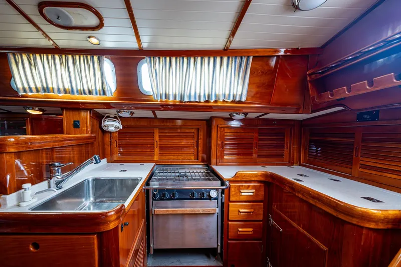Slide: The Image of Luxurious wooden interior of 2000 Hinckley Sou'wester Stoway Sloop yacht kitchen. - 37
