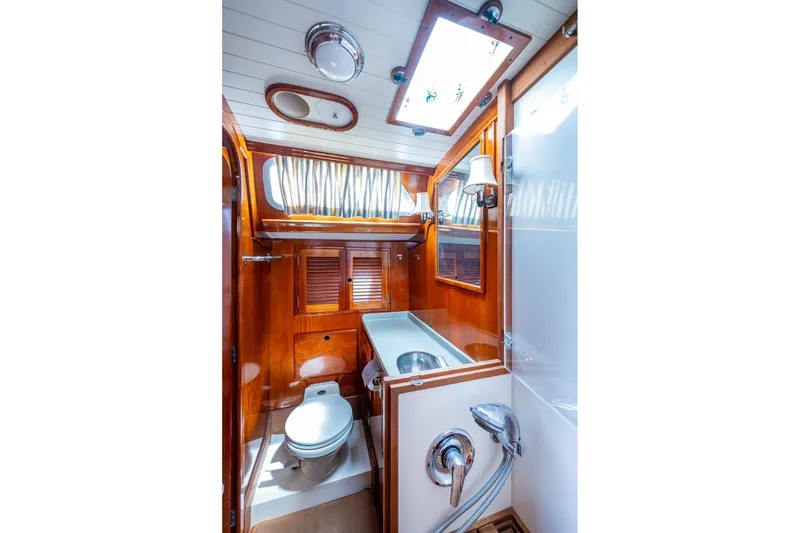 Slide: The Image of Hinckley Sou'wester Stoway Sloop 2000 yacht bathroom with wooden cabinetry and modern fixtures. - 46