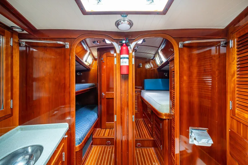 Slide: The Image of Luxurious 2000 Hinckley Sou'wester Stoway Sloop interior with polished wood and cozy bunks. - 56