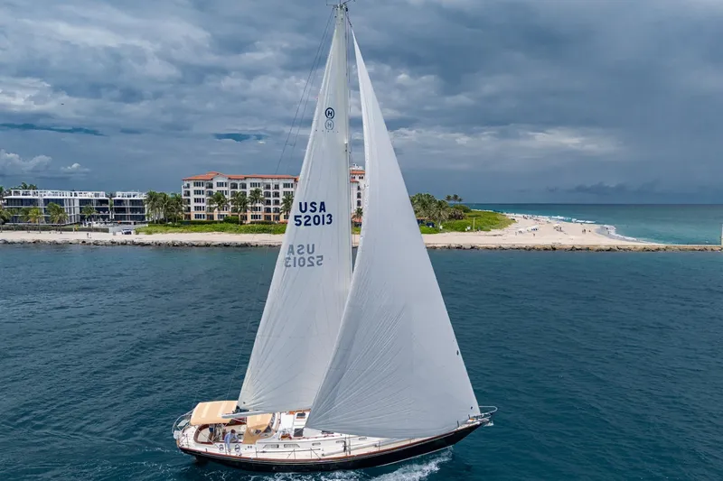 Slide: The Image of Hinckley Sou'wester Stoway Sloop sailing near a scenic coastline, 2000 model. - 6