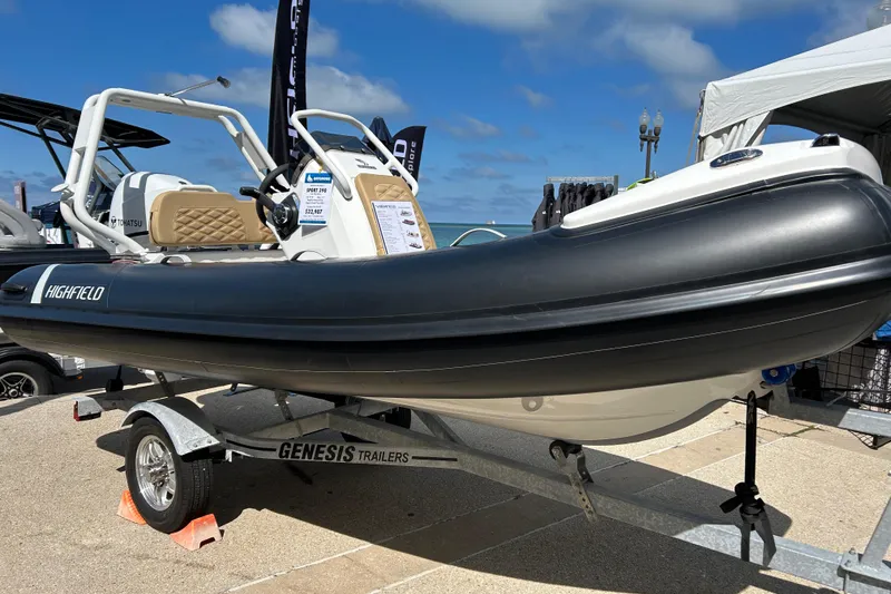 Slide: The Image of 2026 Highfield ADV 7 boat interior with hexagonal-patterned orange seating at a boat show. - 8