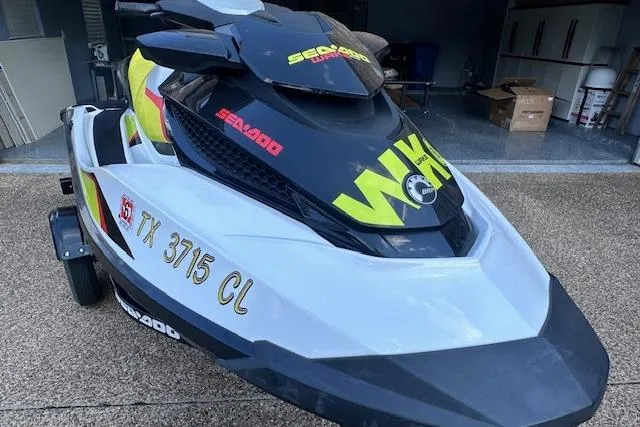 Slide: The Image of 2014 Sea-Doo Wake Pro 215 jet ski in garage, featuring bold graphics and registration number. - 3