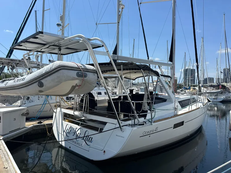 The Image of 2014 Beneteau Oceanis 41 sailboat docked at marina with dinghy on davits. - 0