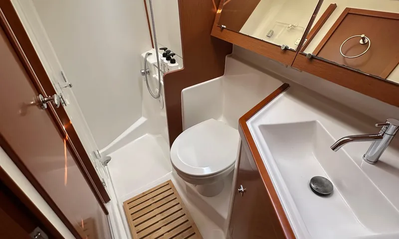 Slide: The Image of Bathroom interior of 2014 Beneteau Oceanis 41 yacht, featuring shower, toilet, and sink. - 10