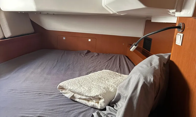 Slide: The Image of Cozy cabin interior of 2014 Beneteau Oceanis 41 sailboat with bed and reading light. - 15