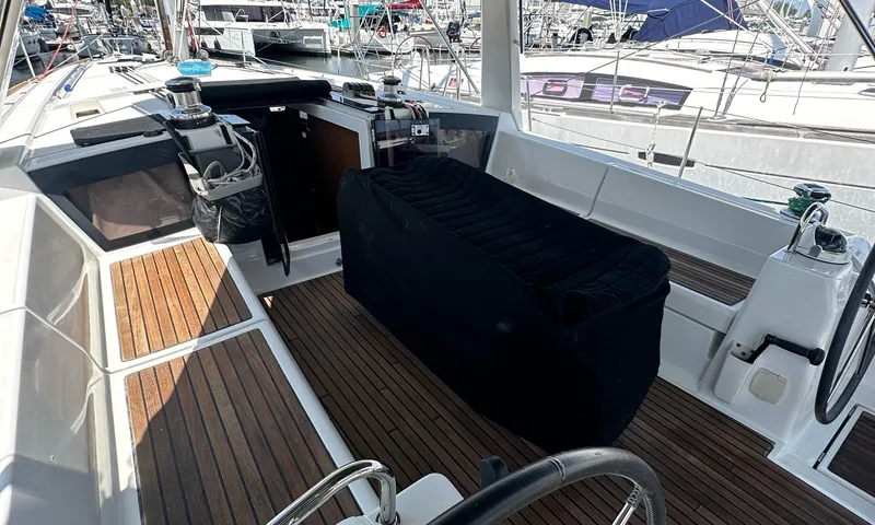 Slide: The Image of Cockpit of 2014 Beneteau Oceanis 41 sailboat with wooden flooring and covered seating. - 18