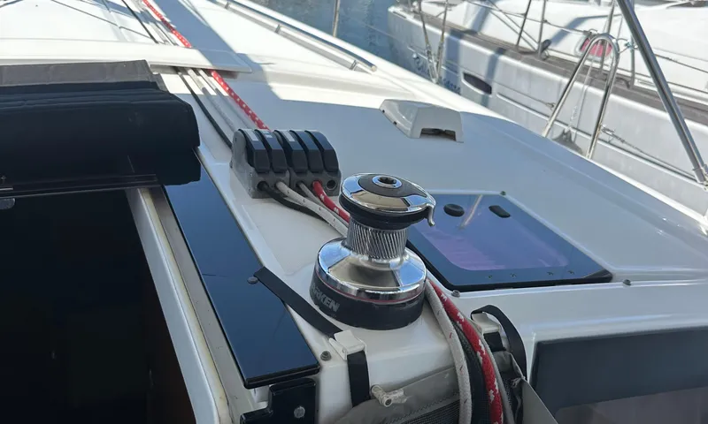 Slide: The Image of 2014 Beneteau Oceanis 41 sailboat deck with winch and ropes. - 21