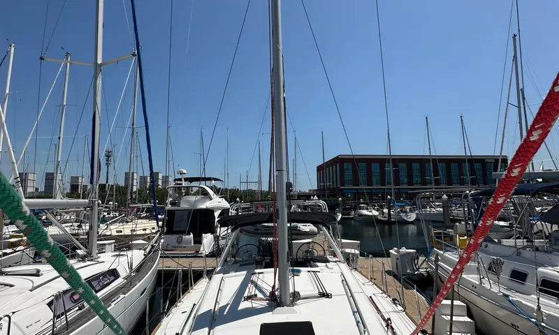 Slide: The Image of 2014 Beneteau Oceanis 41 sailboat docked in a marina under clear blue skies. - 24