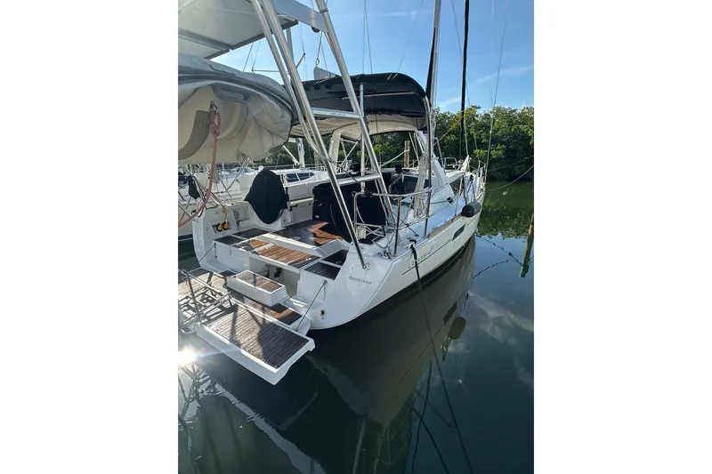 Slide: The Image of 2014 Beneteau Oceanis 41 sailboat docked, featuring a spacious deck and modern design. - 25