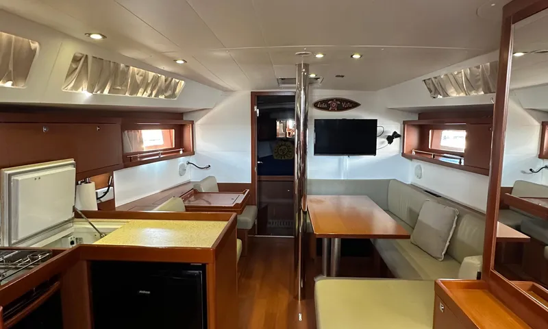 Slide: The Image of Interior of 2014 Beneteau Oceanis 41 yacht with modern kitchen and cozy seating area. - 4