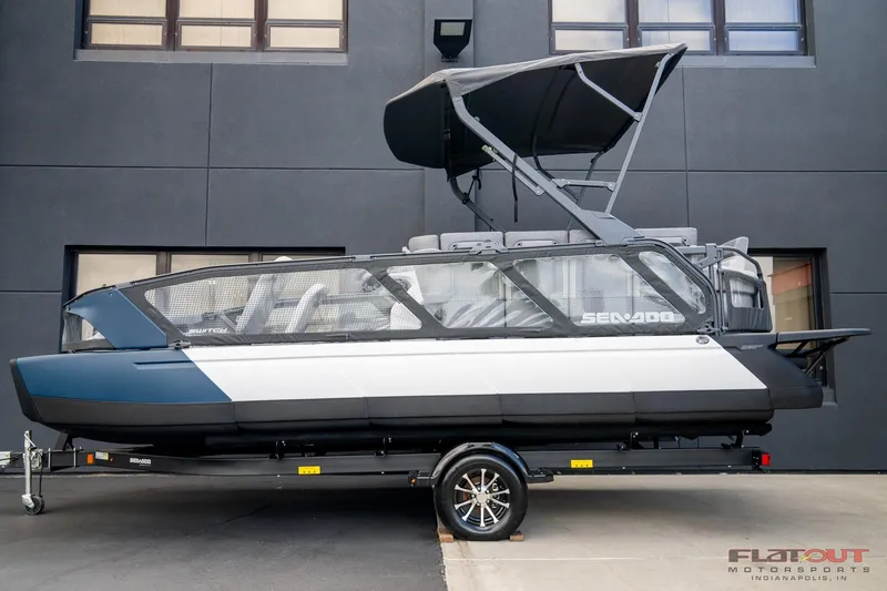 Slide: The Image of 2024 Sea-Doo Switch SPORT 21 230HP pontoon boat on trailer, side view. - 3