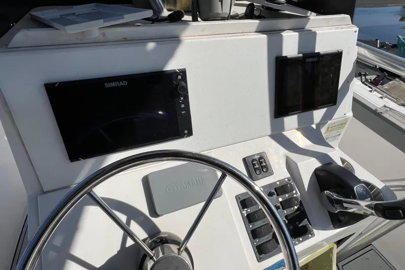 Slide: The Image of Cobia 224 Center Console 2000 helm with Simrad displays and Yamaha controls. - 6