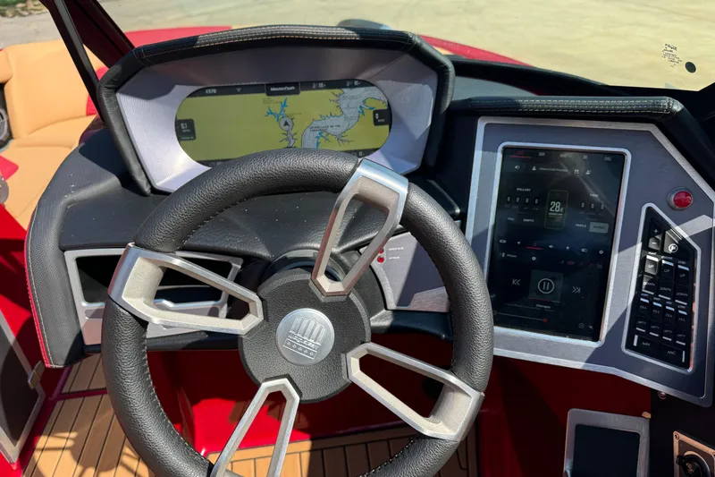 Slide: The Image of 2022 MasterCraft X24 dashboard with steering wheel and digital displays. - 15
