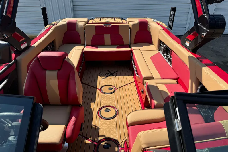 Slide: The Image of 2022 MasterCraft X24 boat interior with red and beige seating, luxury design. - 17
