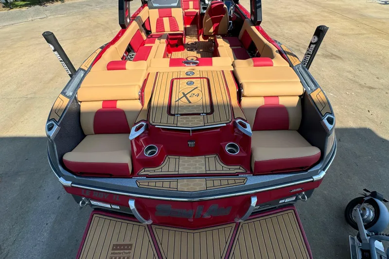 Slide: The Image of 2022 MasterCraft X24 boat with red and tan interior, featuring spacious seating and stylish design. - 6