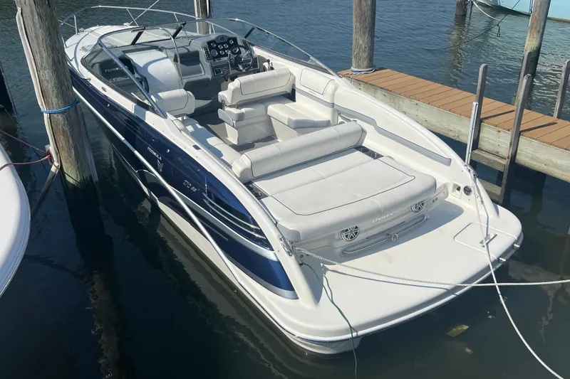 Slide: The Image of 2018 Formula 270 Sun Sport boat docked, featuring sleek design and spacious seating. - 1