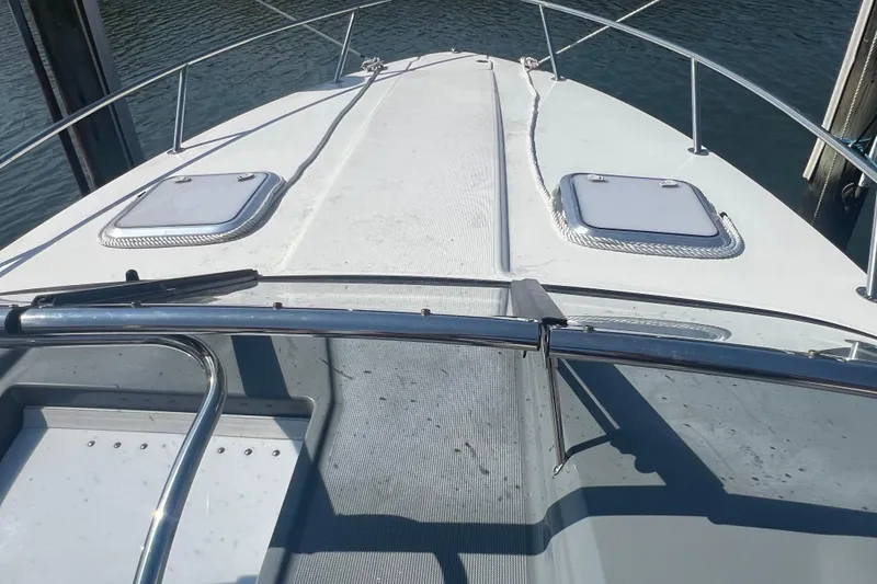 Slide: The Image of 2018 Formula 270 Sun Sport boat deck with hatches, docked on calm water. - 10