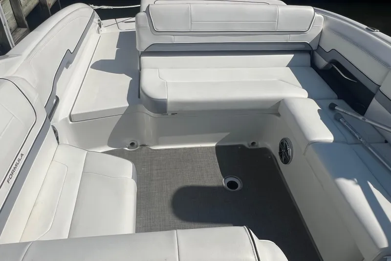 Slide: The Image of 2018 Formula 270 Sun Sport boat interior with white seating and gray flooring. - 11