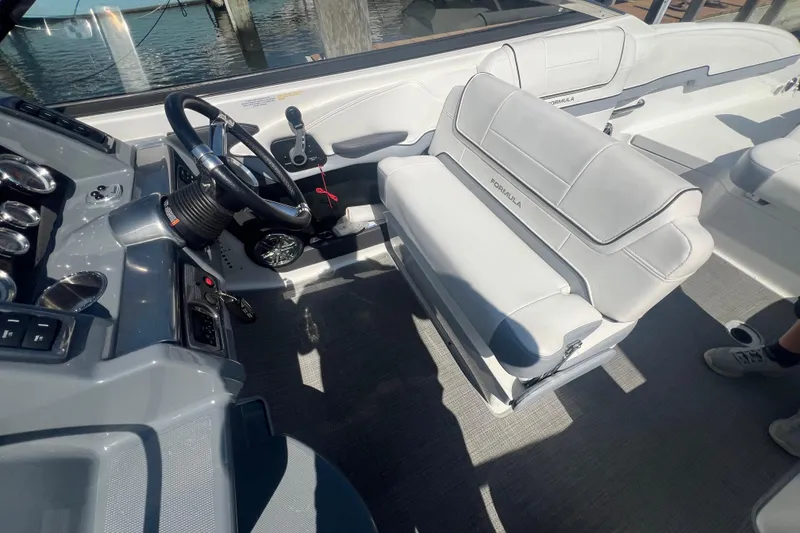 Slide: The Image of 2018 Formula 270 Sun Sport boat interior with steering wheel and seating. - 13