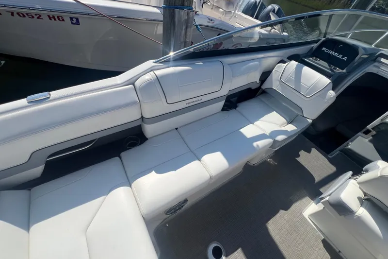 Slide: The Image of 2018 Formula 270 Sun Sport boat interior with white seating and sleek design. - 16