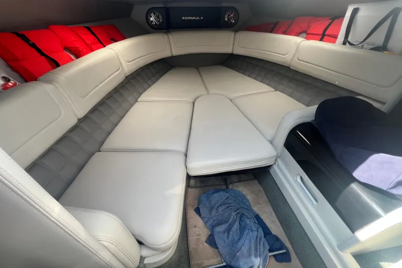 Slide: The Image of 2018 Formula 270 Sun Sport cabin interior with cushioned seating and life jackets. - 18