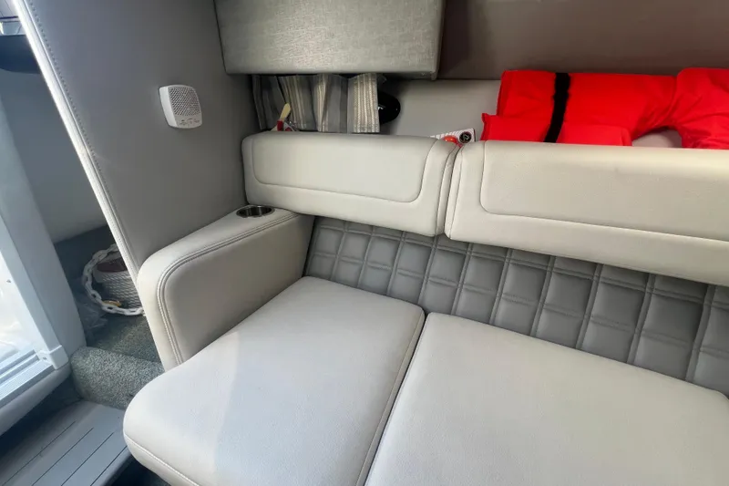 Slide: The Image of Interior of 2018 Formula 270 Sun Sport boat with cushioned seating and life jacket. - 20